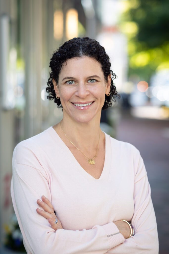 Outdoor professional headshot of smiling woman