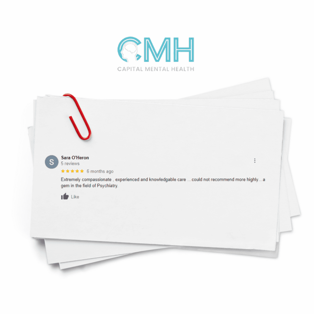 Stack of business cards clipped together with a red paperclip on a white background.